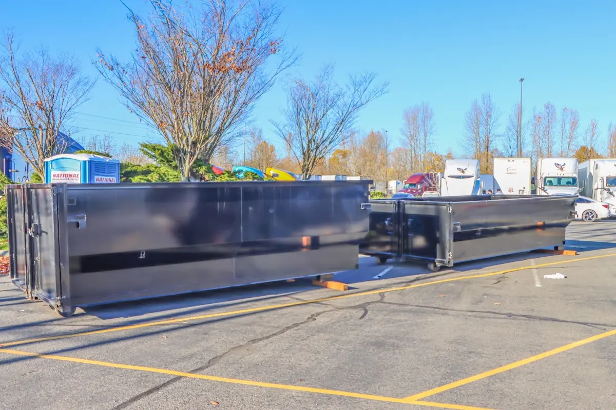 Professional dumpster rental service with roll-off container on residential driveway in Fox Point